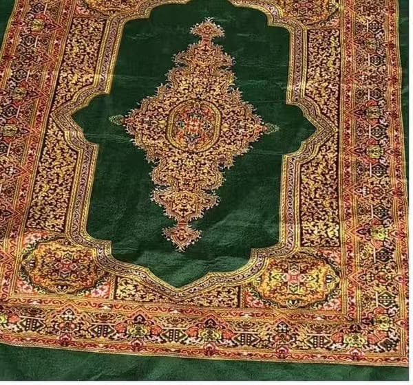 Green traditional carpet produced in the Sa Kaeo factory program