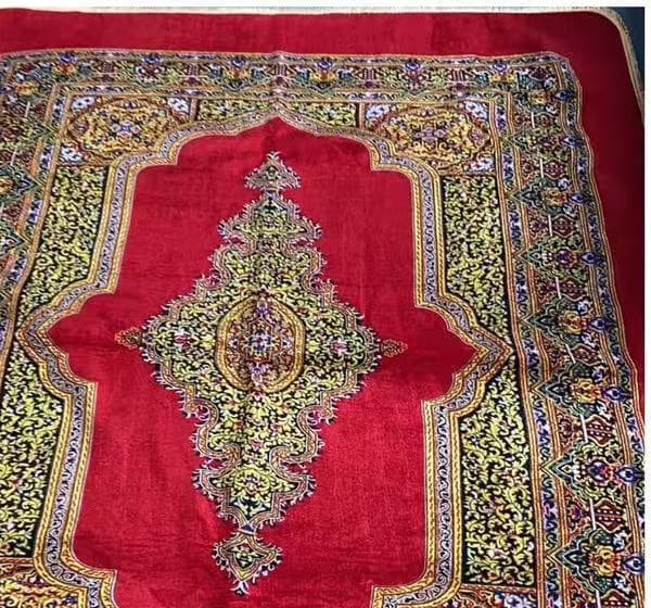 Red traditional carpet produced in the Sa Kaeo factory program